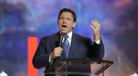 FILE - Florida Gov. Ron DeSantis addresses attendees during the Turning Point USA Student Action Summit, July 22, 2022, in Tampa, Fla. GOP leaders say state policies such as low tax rates and keeping business open during the pandemic helped to fuel hiring and investment. But their claims tend to ignore how job growth was also boosted by a historic injection of federal money that began in March 2020 and continued under Biden with last year's $1.9 trillion coronavirus relief package. (AP Photo/Phelan M. Ebenhack, File)