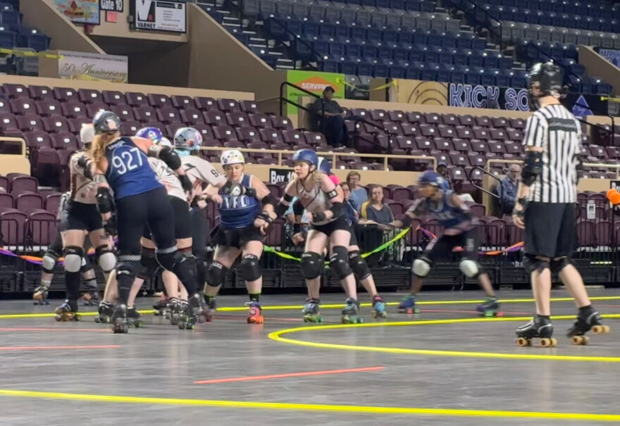 Twin Valleys Roller Derby jammer Black Bolt (second from right) prepares to hit the pack during a game against the Carolina Bootleggers.