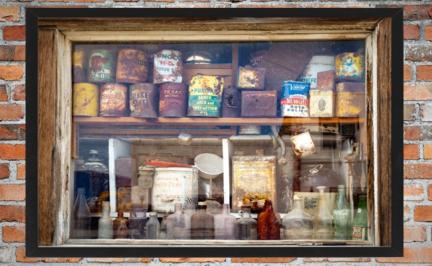 Bottles and tins from years gone by line the storefront window of an abandoned building in Shoshoni, Wyoming.