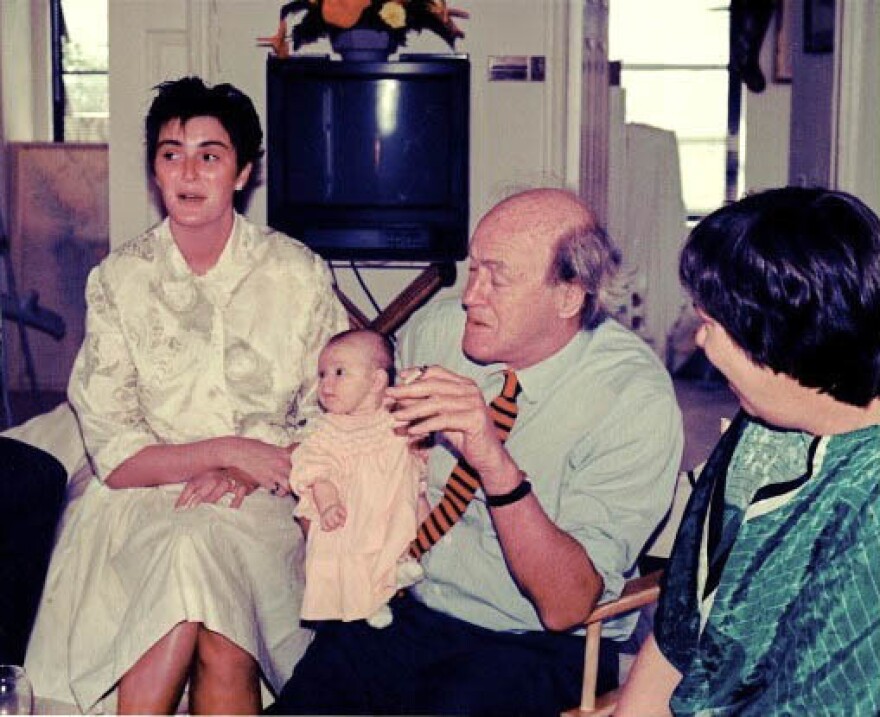 Roald Dahl holds his infant granddaughter, Chloe. Lucy Dahl is pictured at left.