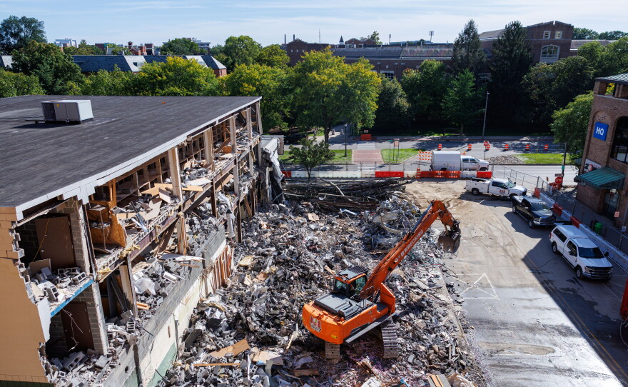 Demolition crews tear down the former Spartan Bookstore in East Lansing, Mich., on Sept. 14, 2026. A new apartment high-rise will be built on the site.