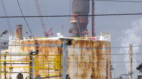 FILE--In this Sept. 18, 2009, file photo, a man works at the Exxon Mobil refinery in Baytown, Texas. Exxon Mobil says it plans to spend $2 billion to expand a chemicals plant next to the Houston Ship Channel and that the project will create 2,000 temporary construction jobs. The company said Thursday, May 2, 2019, it will build a new unit at the Baytown plant to make chemical compounds that give plastics more elasticity and flexibility, and produce ingredients used in engine and industrial oils. Exxon says the facility should begin operating in 2022.
