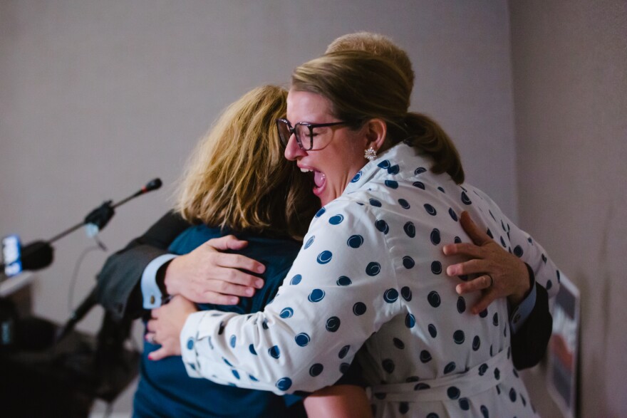 Jake Zimmerman hugs his wife Megan and son Gabriel after being announced as the democratic county executive candidate at the Residence Inn in Clayton on Tuesday, Aug. 4, 2026.
