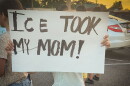 A child protests the ICE arrest of 121 people from a restaurant in Memphis on Aug. 31.