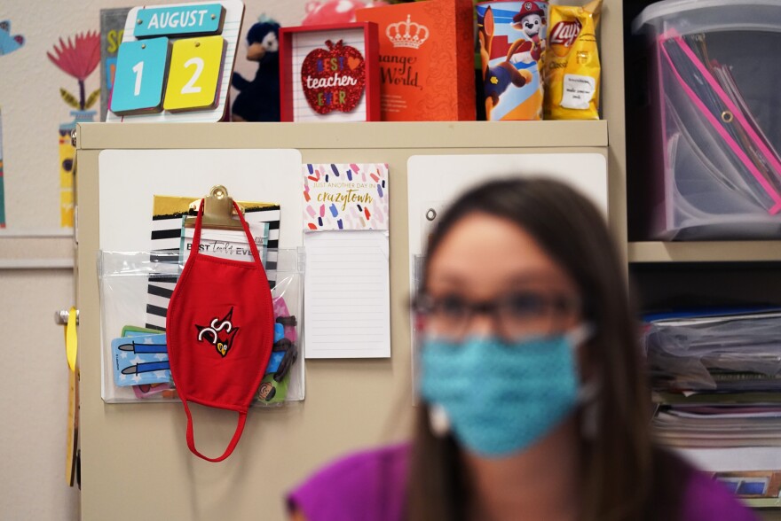 kindergarten teacher Amber Ximenz prepares her classroom at Southside Independent School District, Thursday, Aug. 13, 2020, in San Antonio.