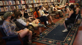 Audience members engage in a pre-show discussion before the screening of "Can't Stop Change: Queer Climate Stories From the Florida Frontlines" at the Civic Media Center in Gainesville. (Azhalia Pottinger/WUFT News)
