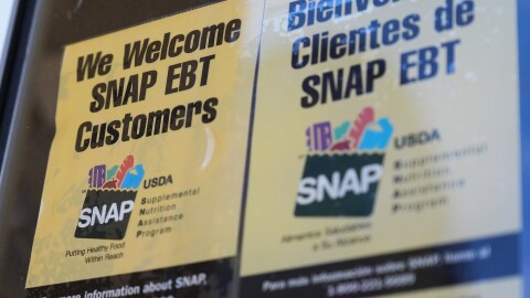 A SNAP EBT information sign is displayed outside of a convenience store in Baltimore, Monday, Nov. 10, 2025.