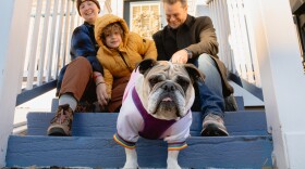 Elle Brodsky, left, Troika Brodsky, right, their son Daniel, 6, and their foster dog, a 3-year-old English Bulldog named Bella sit outside their Maplewood home on Tuesday, Jan. 20, 2026. The Brodsky’s home is intersected by the St. Louis County and city divide.