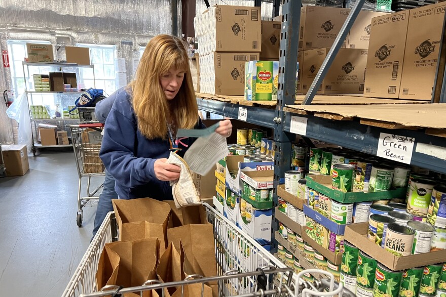 Sue Daganhardt, a volunteer at the Falmouth Service Center food pantry, fulfills a client's grocery order, Nov. 21, 2025.