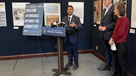 State Sen. Jeremy Cooney, left, lays out details of his legislation that would allow employees to use pre-tax earnings to pay for commuting expenses. On the right are Bob Duffy, president and CEO of the Greater Rochester Chamber of Commerce, and Marry Staropoli, co-executive director of Reconnect Rochester.