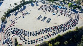 Cars are lined up at Dodger Stadium in Los Angeles for coronavirus testing. Nearly 2 million people are getting tested a day in the U.S. A new analysis shows millions more are needed to protect the most vulnerable.