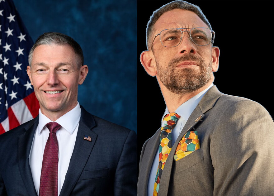 Two photos of white men sit side by side. On the left is a middle-aged man with greying short hair. He wears a navy blue suit jacket with an American Flag pinned to his left collar. Underneath the jacket is a maroon tie and a white button down shirt. The American Flag is to the left of him in the background and on the right is a washed looking dark blue background. The right photo is a sticker of a man with short brown hair and facial hair. He wears a khaki suit jacket with a colorful handkerchief in his breast pocket. It matches his tie with yellow, orange, turquoise, some red and blue geometric shapes. Underneath he wears a light blue button down shirt.