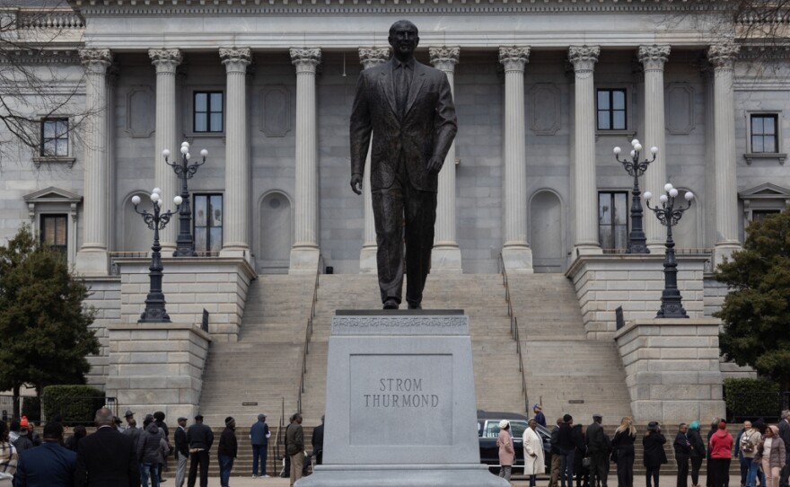 Visitors in line to see Jesse Jackson lie in state behind a statue of
