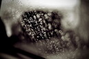 When raindrops approach the front windshield, they are too heavy and are going too fast to suddenly change direction and be swept up and away from the glass.