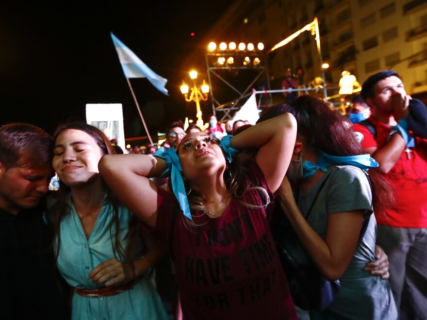 Anti-abortion activists outside Congress in Buenos Aires react Wednesday after lawmakers passed a bill that legalizes abortion.