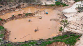 FILE - Dredges used for illegal mining sit near the Malinowski River in the Tambopata National Reserve in Puerto Maldonado, Peru, Aug. 11, 2026.