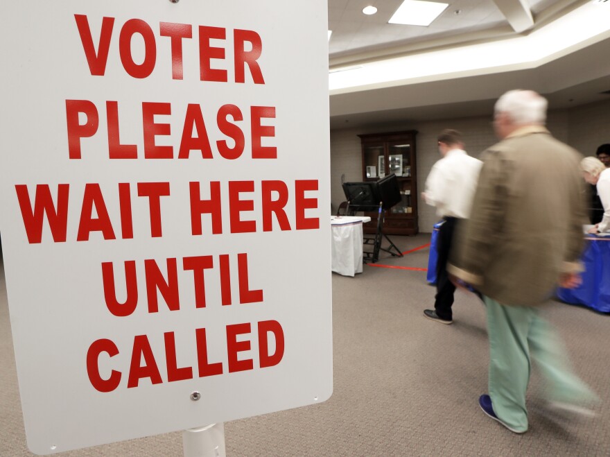 Voters are escorted to voting machines on Election Day Tuesday, Nov. 8, 2016, in Nashville, Tenn.