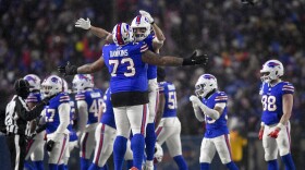 Buffalo Bills offensive tackle Dion Dawkins (73) and tight end Dalton Kincaid (86) celebrate as time winds off the clock of an NFL divisional playoff football game against the Baltimore Ravens, Sunday, Jan. 19, 2025, in Orchard Park, N.Y. (AP Photo/Adrian Kraus)