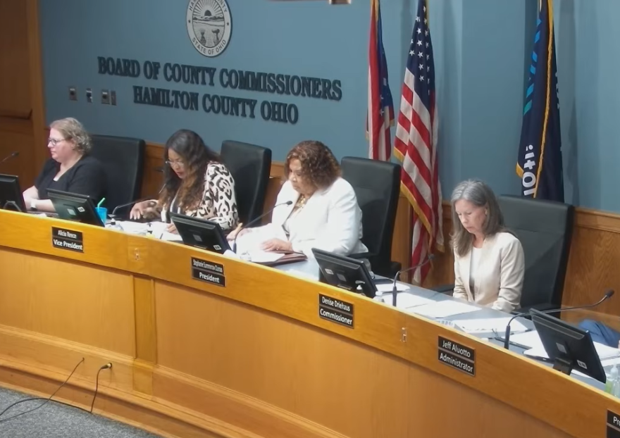four women seated at a dais