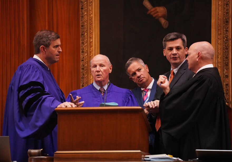 House Spearker Murrell Smith, R-Sumter, Senate President Thomas Alexander, R-Oconee, assistant Senate Parlimentarian John Hazzard, Senate Majority Leader Shane Massey, R-Edgefield, and Senate Clerk Jeffrey Gossett, confer on the dais in the Senate at the South Carolina Statehouse on May 8, 2025, the last day of the 2025 session.