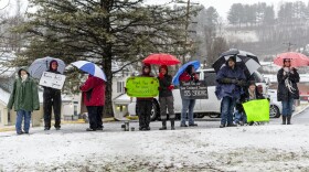 Monongalia County teachers greet motorists at the intersection of Green Bag Road and Kingwood Pike on Wednesday, Feb. 20, 2019 outside Morgantown, W.Va. on the second day of a statewide strike.