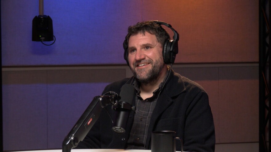 Tyler Lake is shown in Metz Studio recording a podcast episode