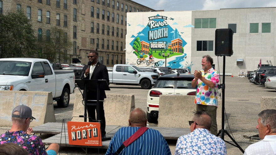 Grand Rapids City Manager Mark Washington (left) speaks to a crowd with River North Business Association President Mark Secchia (right) at the unveiling of the River North District mural.