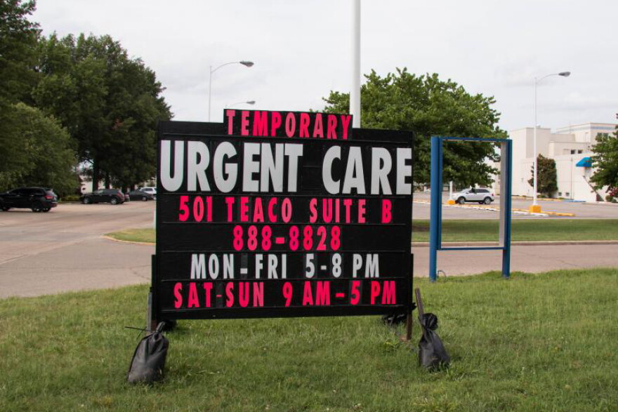 In 2018, a sign behind a closed hospital in Kennett, Missouri advertised a new urgent care center in 2018.