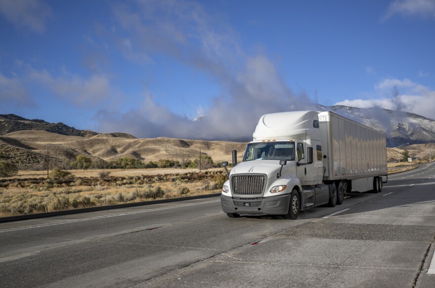 Stock photo of a semi truck driving on a highway.