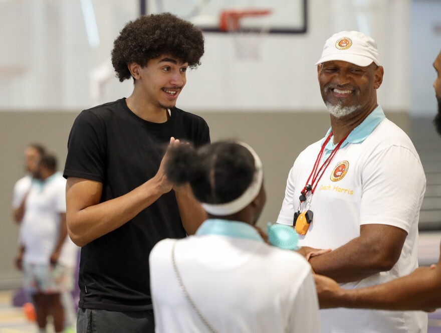 Mitchell Harris, right, talks with David Johnson during the Hoop N’ Holla summer basketball camp in Rochester. Johnson, 16, is ranked fifth nationally by ESPN in the Class of 2029 despite having played basketball for only about three years. Harris and other coaches work with young athletes throughout the year, emphasizing academic success alongside the development of their basketball skills.