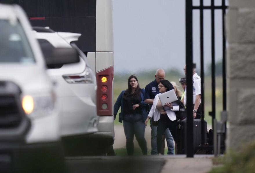 Democrats from the Texas Legislature arrive by bus to board a private plane in Austin to travel to Washington, D.C., on Monday.