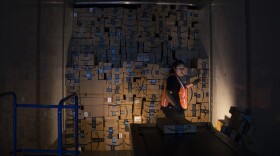 Amazon employee Andrea Neri stacks boxes in the back of a delivery truck on the ship dock at an Amazon fulfillment center on Friday, November 3, 2017, in Kent. 