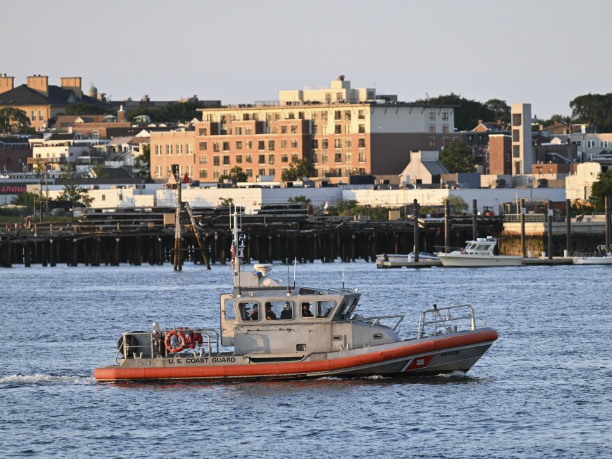 A boat near the U.S. Coast Guard base in Boston, Mass., on Wednesday, where rescue teams are racing to find a missing submersible with five people on board.