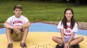 Dominic Rudakevych and Marilyn Fisher, 2014 champions of the National Marbles Championships in Wildwood, N.J., pose at the marbles rings in Middletown, Md. The two 13-year-olds train with the Frederick County Knucklers, a competitive marbles recreational program in Maryland.