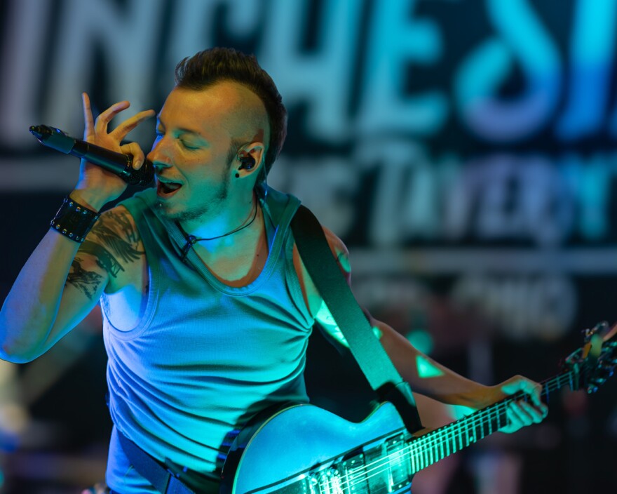 Michael McFarland sings and plays guitar on stage