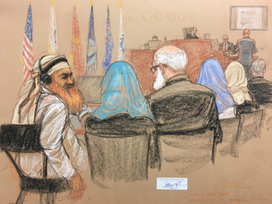 Alleged Sept. 11 mastermind Khalid Sheikh Mohammed (far left) consults with his defense attorneys in the U.S. military courtroom in Guantánamo Bay, Cuba, as a man who waterboarded him, retired Air Force psychologist James Mitchell, takes the stand. [Janet Hamlin Illustration]