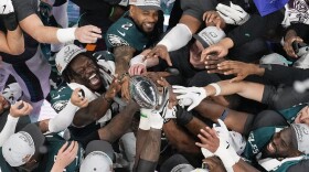 Philadelphia Eagles players celebrate with the Vince Lombardi Trophy after the Eagles won the NFL Super Bowl 59 football game against the Kansas City Chiefs, Sunday, Feb. 9, 2025, in New Orleans. (AP Photo/David J. Phillip)