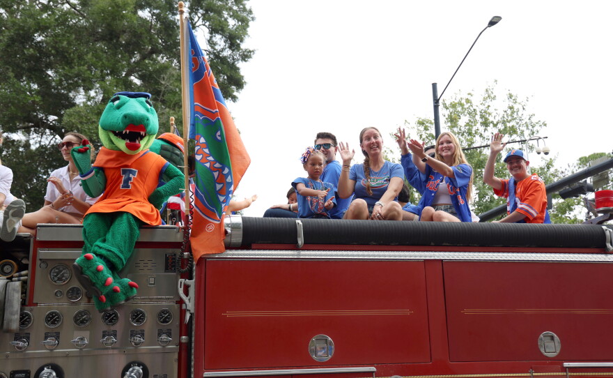 Alberta the Gator sits on Gainesville Fire Rescue truck among UF students and family during the University of Florida Homecoming parade in Gainesville Friday, Oct. 9, 2026. (Alessia Lavayen/WUFT News)