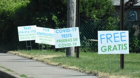 Signs in English and Spanish near a COVID-19 testing site in Goshen, Indiana.