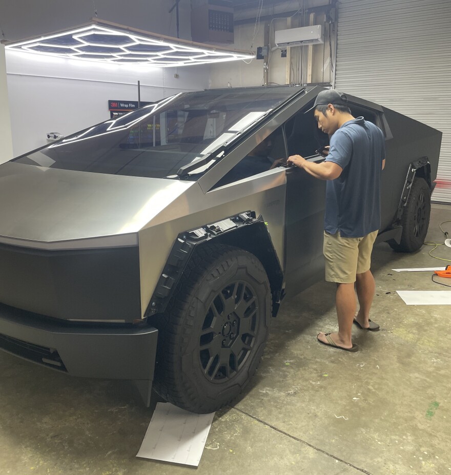 Ji Hoon Heo, at work on a Tesla in the garage.