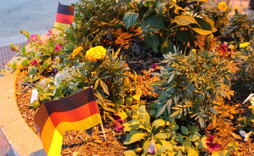 German flags dot a flower bed outside the venue of Thursday's 50th anniversary dinner celebrating Peoria's sister city partnership with Friedrichshafen, Germany.