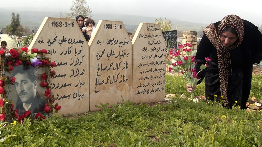 A Kurdish woman places flowers at graves of her loved ones in Halabja, Iraq, on March 16, 2007, as Kurds in northern Iraq commemorated the anniversary of a 1988 chemical weapons attack that killed an estimated 5,600 people.