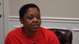 A woman with short, black hair and a red shirt.