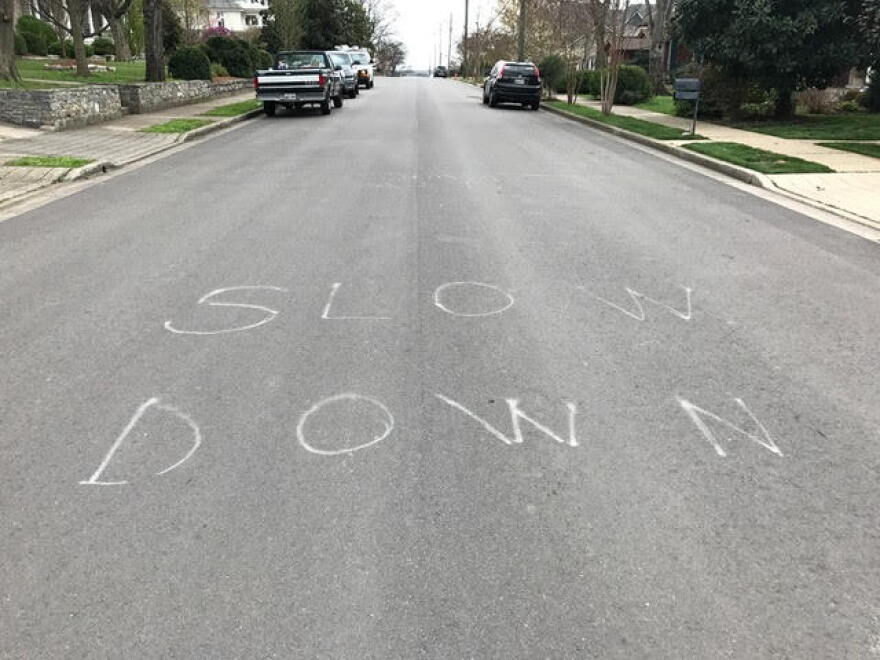 Some neighborhood vigilantes have been trying to slow traffic in whatever ways they can — like painting "slow down" in the street. (John Buntin/WPLN)