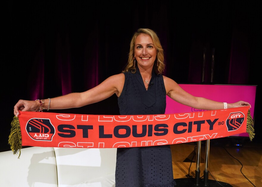 Team CEO Carolyn Kindle Betz, displays the name of the soccer team — St. Louis City SC — their colors and crest during a virtual press conference at Harris-Stowe State University in St. Louis on Thursday.