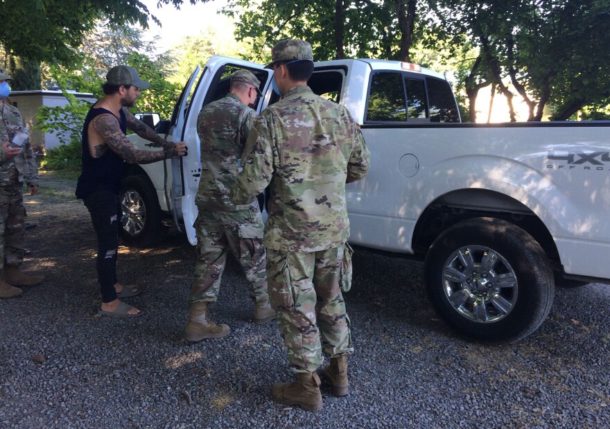 National Guardsmen load Sean Steeve's truck with face masks and hand sanitizer for his workers at RDSP Farms, an industrial hemp farm based in Ashland.