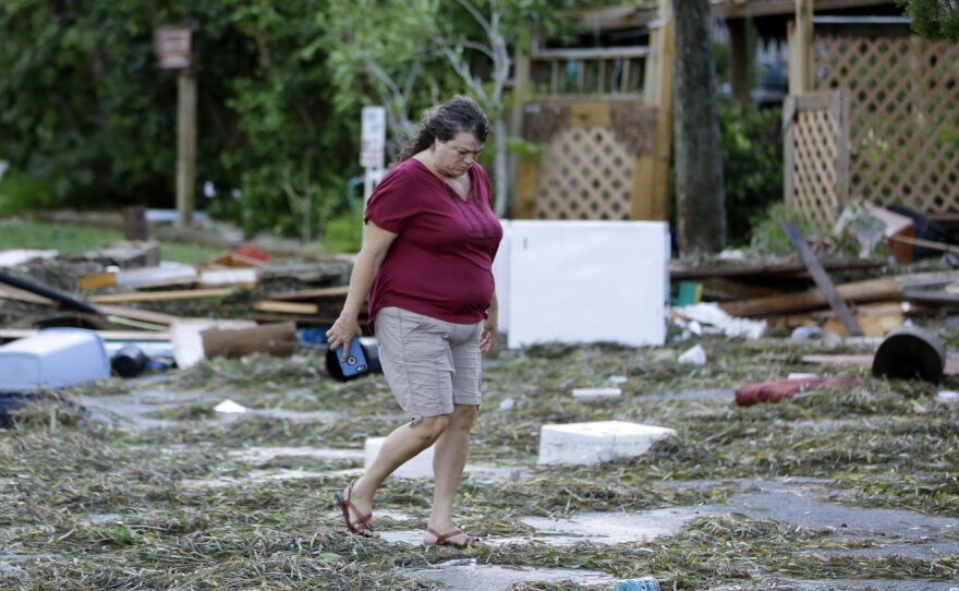 A resident checks on damage from Hurricane Hermine Friday, Sept. 2, 2016, in Cedar Key, Fla. Hermine was downgraded to a tropical storm after it made landfall. (AP Photo/John Raoux)