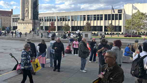 People gathered holding signs