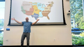 Nick Hylla, executive director of the Midwest Renewable Energy Association, explains why the cost of electricity has soared in the past five years during a presentation at the Bloomington Public Library.