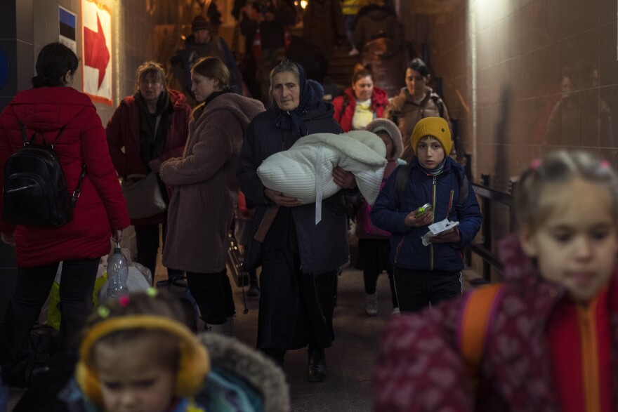 <strong>March 15:</strong> People who fled the war in Ukraine leave the train station in Przemysl, Poland.